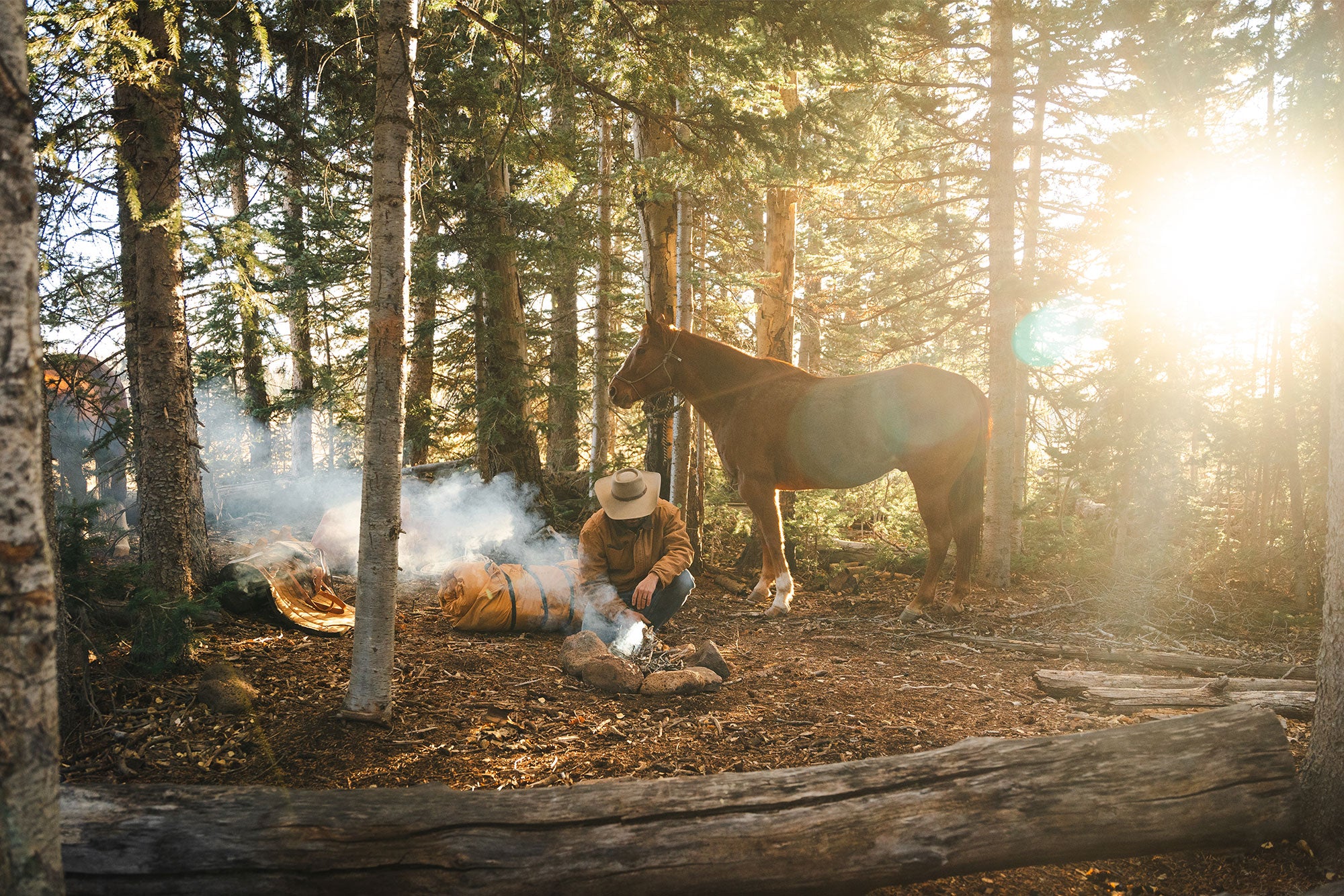 Cowboy sleeping next to campfire with Canvas Cutter Bedroll