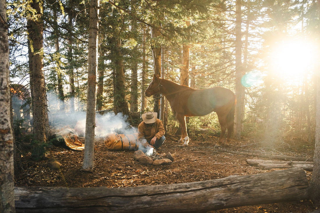 Cowboy sleeping next to campfire with Canvas Cutter Bedroll