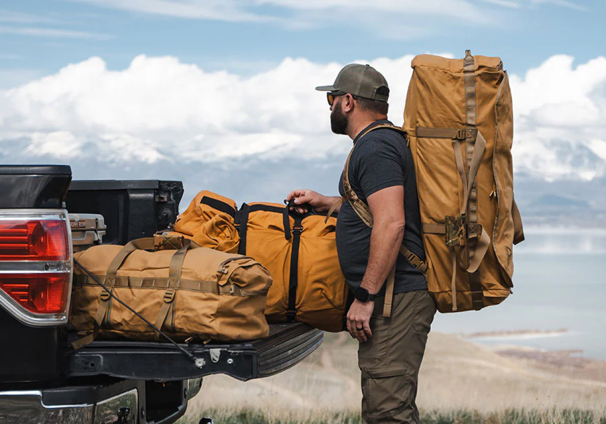 Heavy-duty canvas duffel bag loaded in truck bed during hunting trip