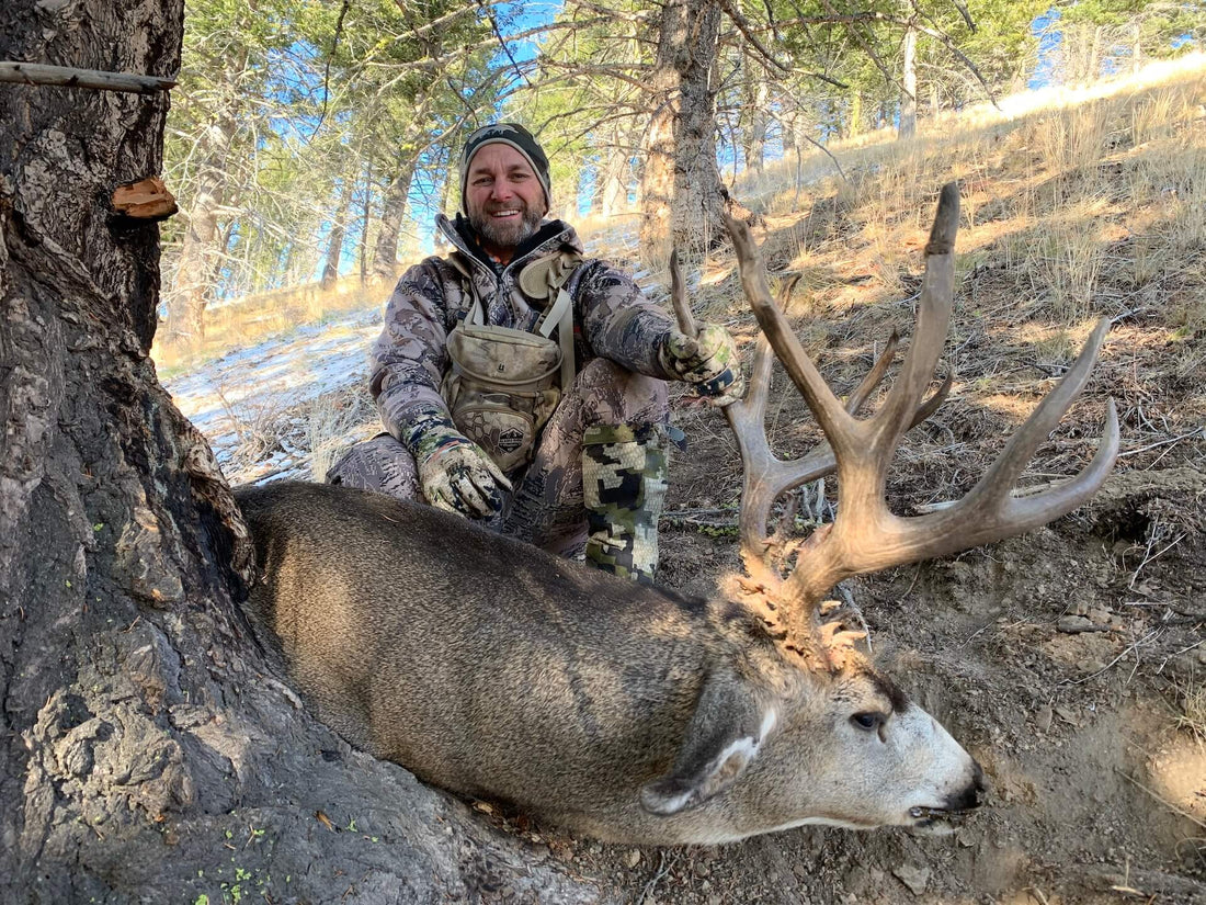 group of hunters in field scouting for mule deer in oak and sagebrush country