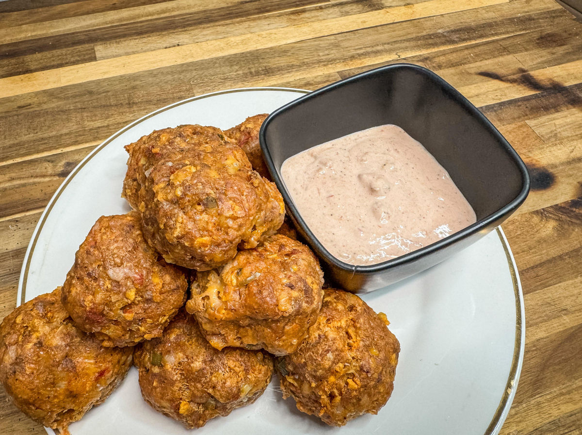 Wild game appetizer platter with sausage balls and dipping sauce