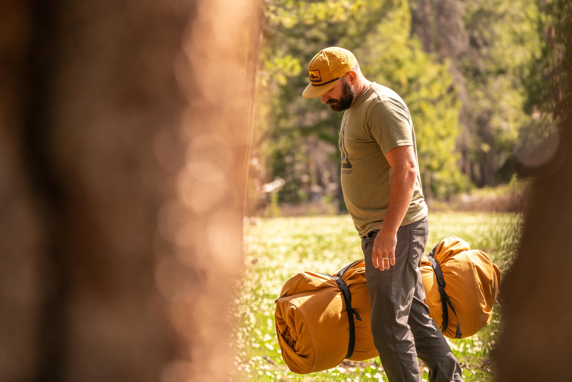 Man carrying a rolled up Canvas Cutter bedroll