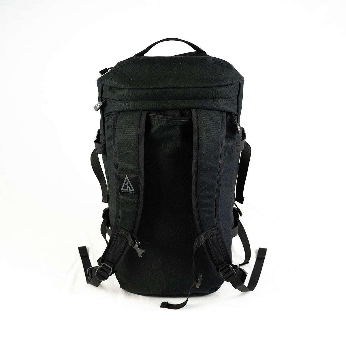 Black Burro duffel backpack showing padded shoulder straps and back panel