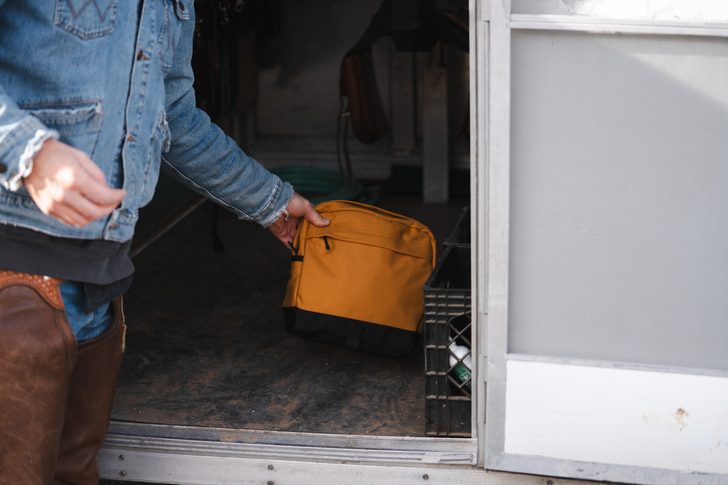 Canvas saddle bags detached from saddle and set on trailer