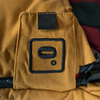 Close up of the Bunker Bag canvas shell showing stitched logo patch and durable fabric construction on the zip cover