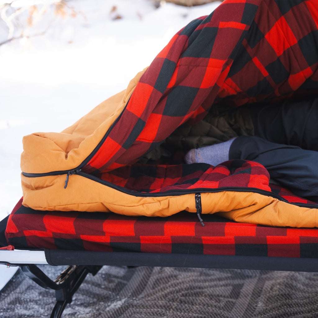 Bunker Bag paired with a Dominator Bedroll on a cot showing integrated sleep system setup
