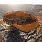 Canvas Cutter Bunker Bag paired with a Dominator Bedroll on a cot for elevated sleeping