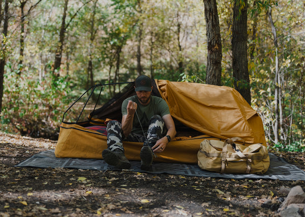 Canvas Cutter 3.0 bedroll laid out at camp, featuring upgraded canvas construction built for rugged camping and hunting trips