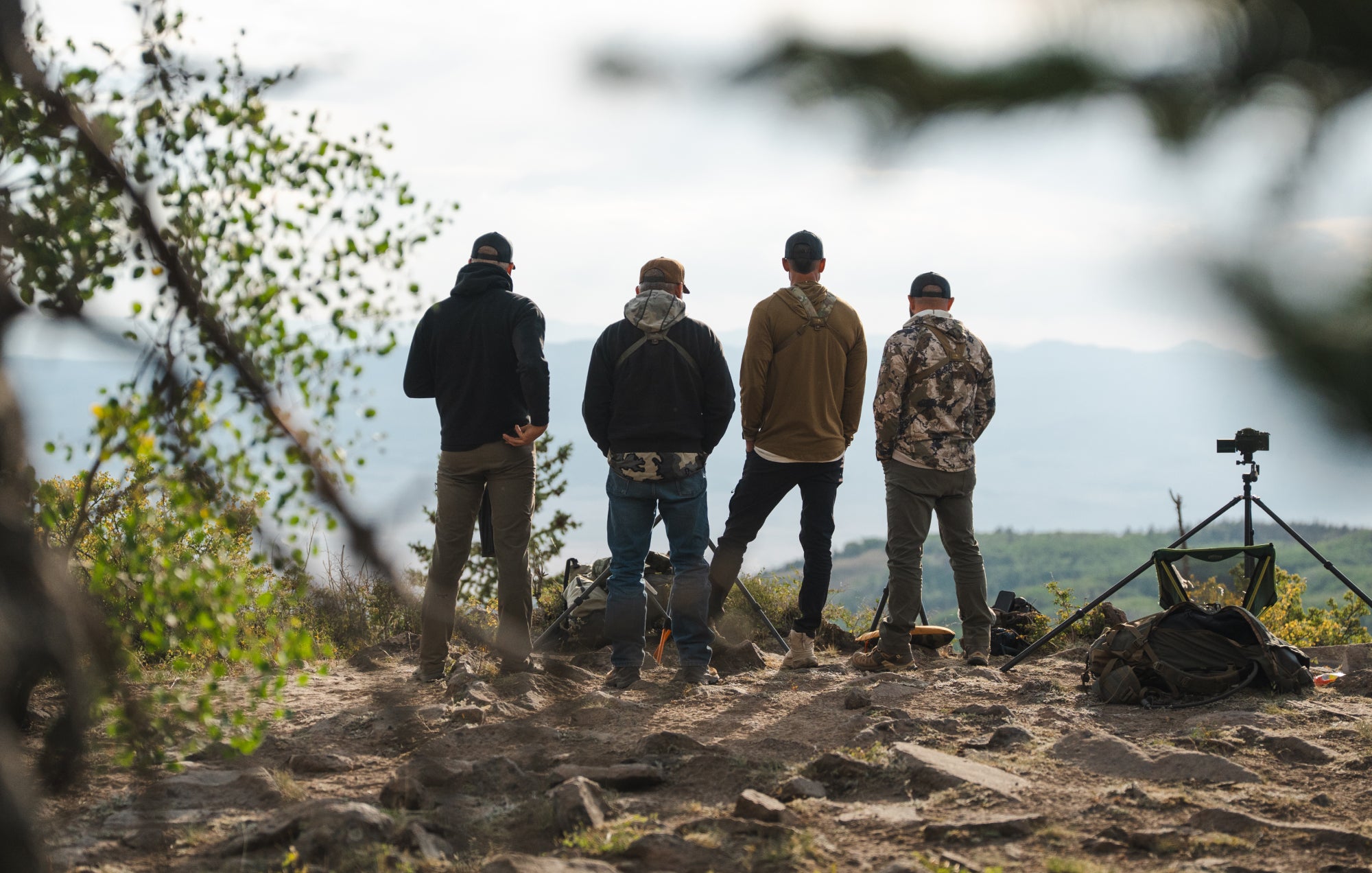 Canvas Cutter team overlooking a mountain landscape during a camping trip, representing time outdoors, rugged gear, and the camping lifestyle