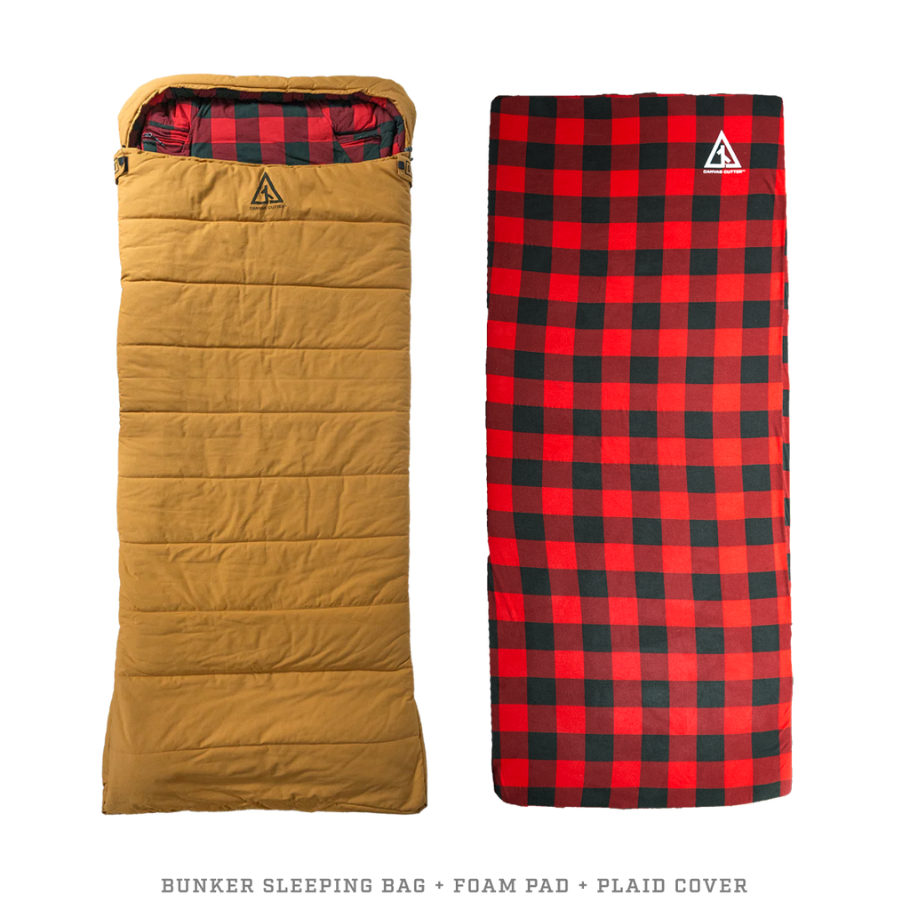 Canvas sleeping bag with thick foam sleeping pad laid out for camping sleep system
