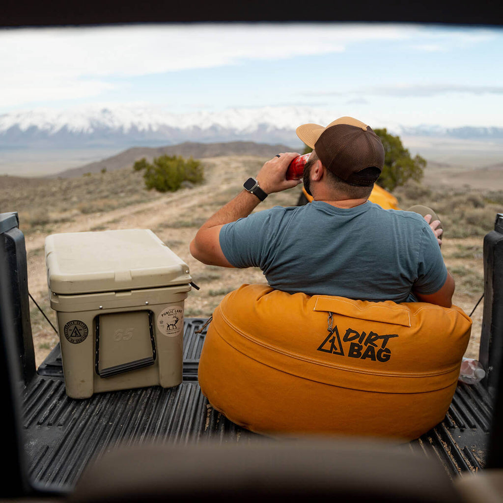 Rear view of Dirt Bag canvas bean bag set up outdoors in the back of a truck while hunting