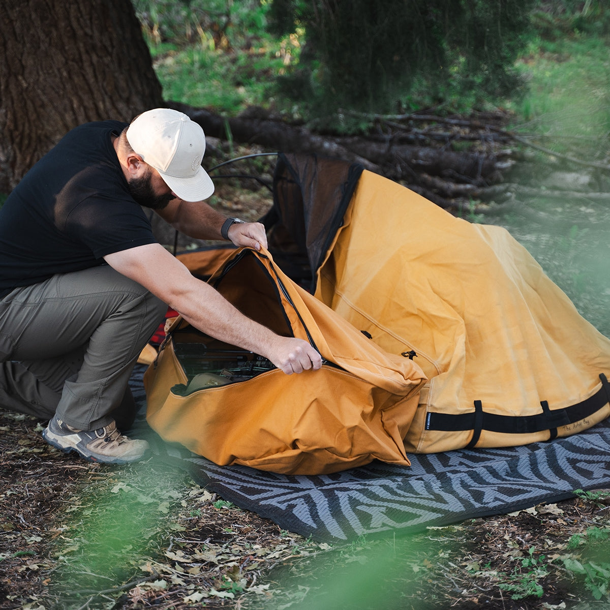 Camper accessing The Locker while the Canvas Cutter bedroll is set up outdoors