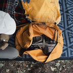 The Locker packed with camping gear and positioned next to a Canvas Cutter bedroll