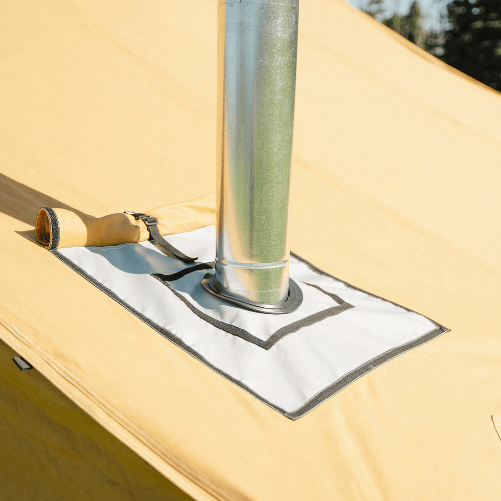 Close up of stove jack and flue installed on the Stronghold canvas wall tent