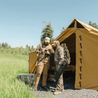 Hunters standing outside a Stronghold modular wall tent at base camp
