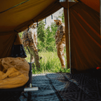 Interior view looking out of the Stronghold wall tent entrance during camp setup