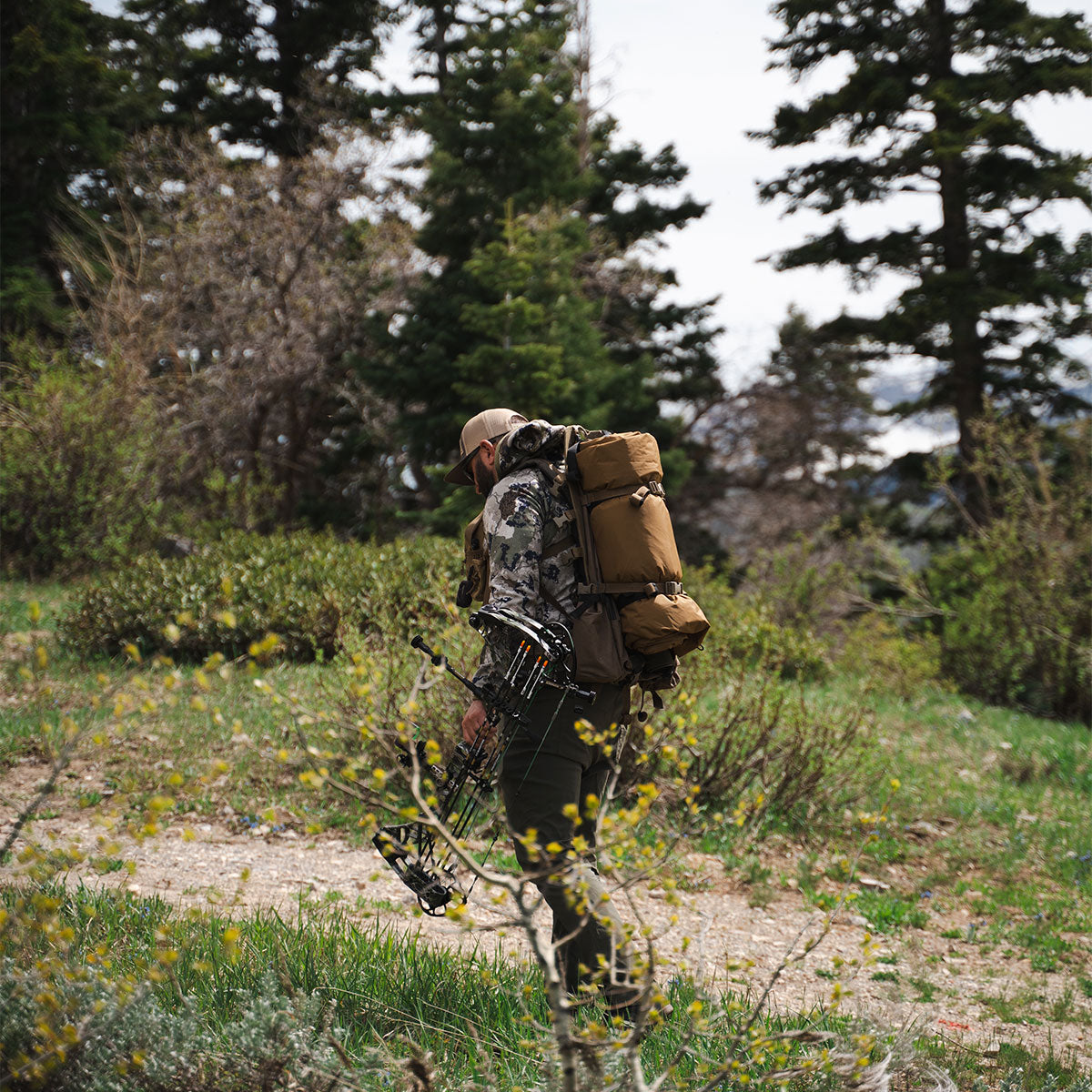 Backpacker hiking while hunting with the Summit Sleep System packed for lightweight travel