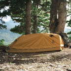 Summit Sleep System set up outdoors in a forest environment showing low profile and weather protection