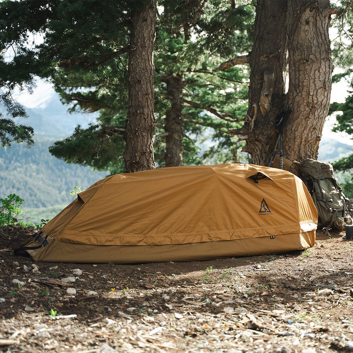 Summit Sleep System set up outdoors in a forest environment showing low profile and weather protection
