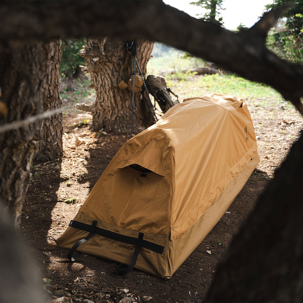 Summit Sleep System set up in a forest showing low profile bivvy shelter design